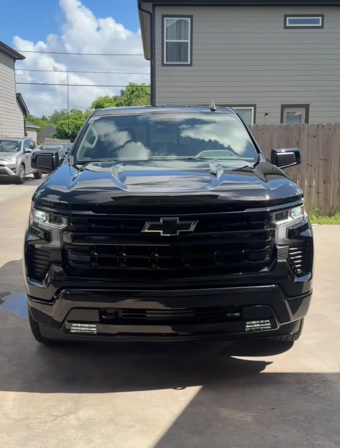 Glossy black detailed truck with mirror-like paint reflections
